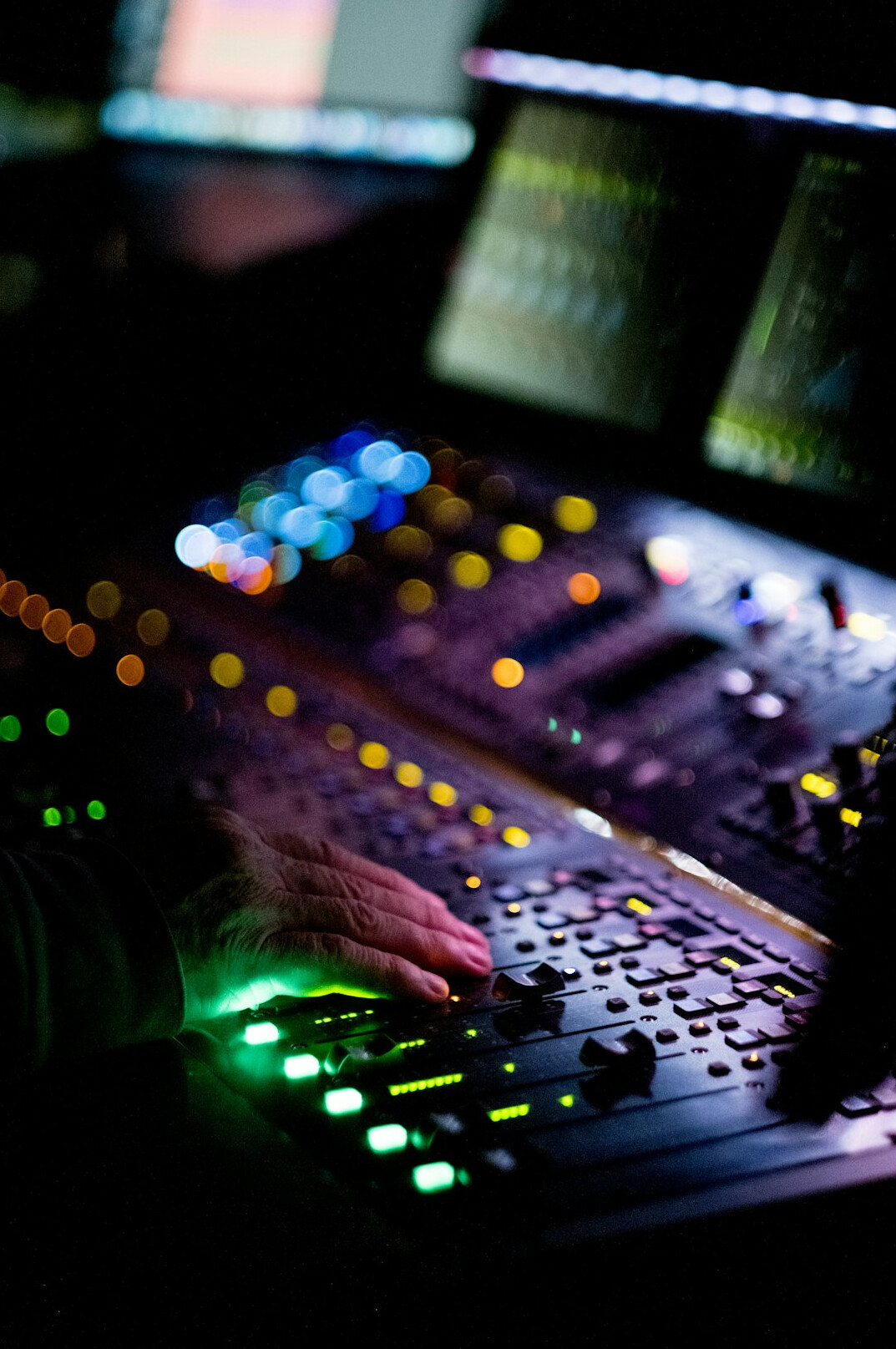 Television control room with multiple monitors and mixing console