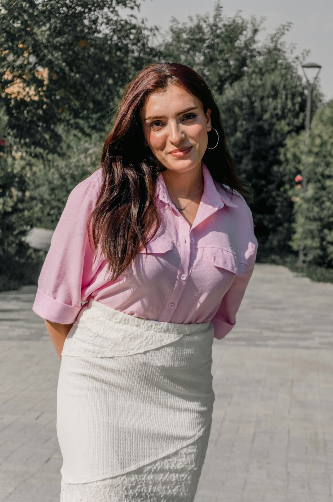 Studio portrait of a European woman with shoulder-length brown hair smiling